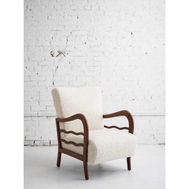 Mid-century Italian armchair in the style of Paolo Buffa. Newly reupholstered in cream-colored wool boucle with sculptural...