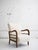 Mid-century Italian armchair in the style of Paolo Buffa. Newly reupholstered in cream-colored wool boucle with sculptural...