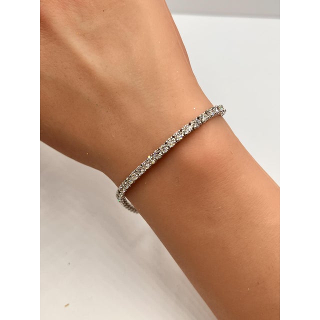 This exquisite 5.6 Carat Diamond Tennis Bracelet is a masterpiece of elegance and sophistication. Featuring a series of...