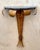 This vintage gilt metal wall console pairs sculptural, nature-inspired ironwork with the quiet luxury of a demi-lune...