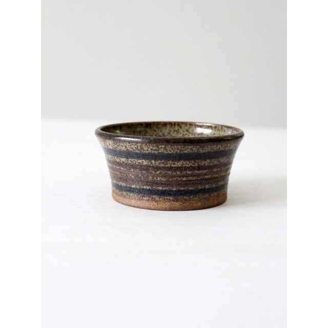 This vintage studio pottery bowl is signed by the artist and features a warm speckled brown glaze. The small handmade bowl...