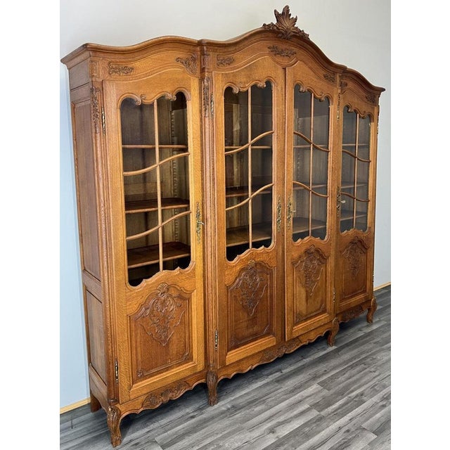This impressive Vintage French Louis bookcase is a grand and elegant display piece, beautifully crafted with glazed doors...