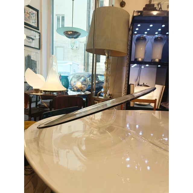 A sculptural centrepiece made from fine, transparent blown glass. The piece is characterised by its wide, almost flat...