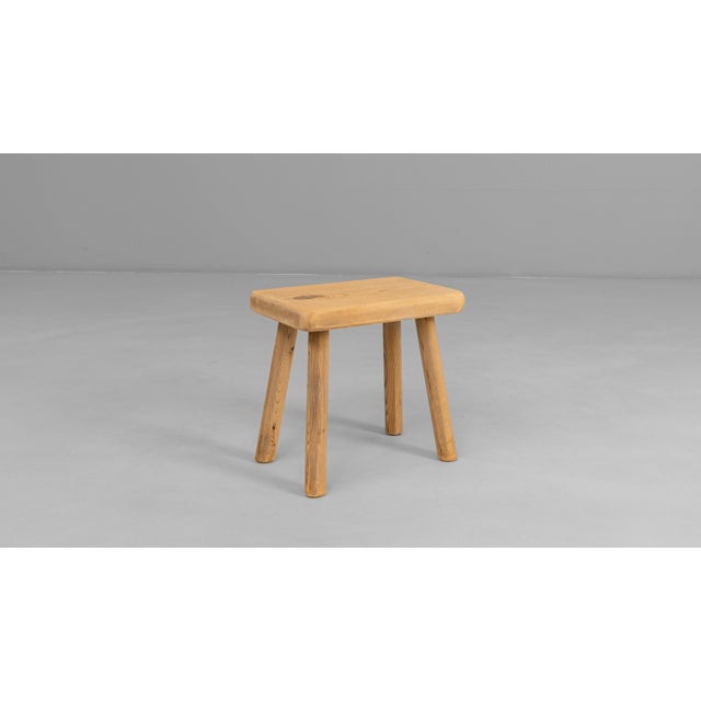 This 20th Century French primitive wooden stool embodies the simplicity and honesty of traditional rural craftsmanship....