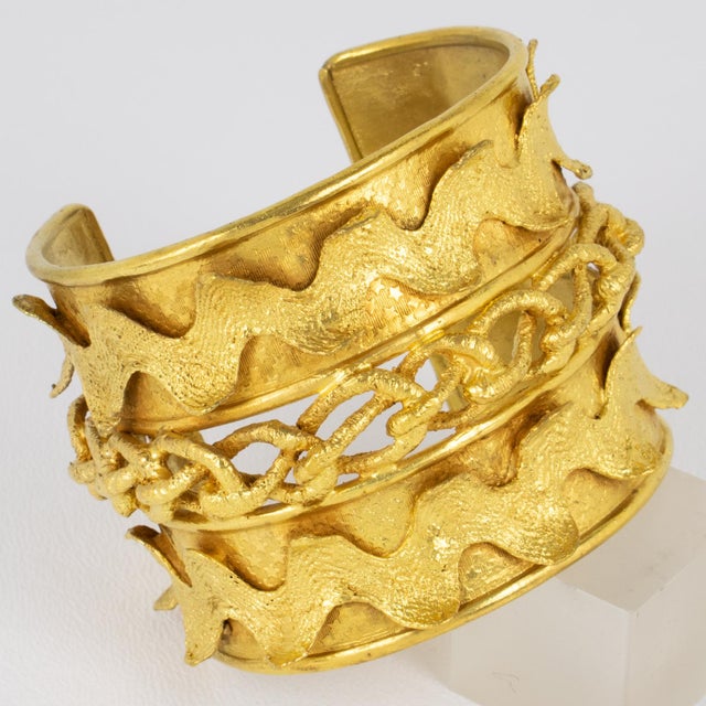 This spectacular Mercedes Robirosa bangle bracelet boasts a massive baroque cuff shape with gilt metal that is all...
