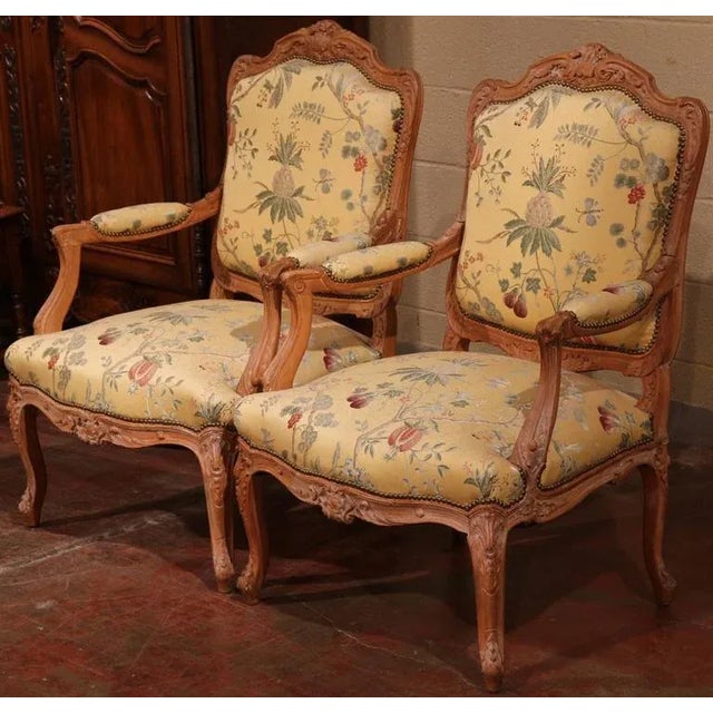 This elegant pair of antique armchairs was crafted in France circa 1920 in the Louis XV style. Each fauteuil is built of...