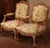 This elegant pair of antique armchairs was crafted in France circa 1920 in the Louis XV style. Each fauteuil is built of...