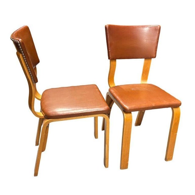 Pair of Mid-Century bentwood side chairs with brown Naugahyde seat covers and decorative steel nail-head seat back by...