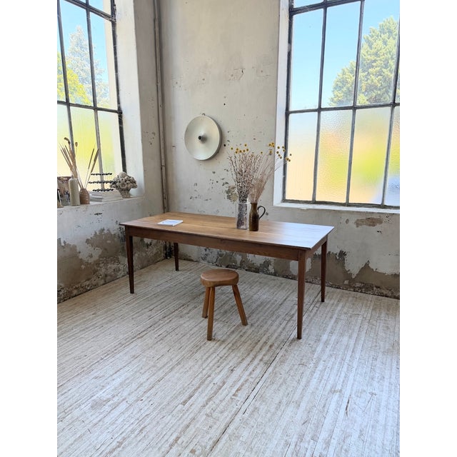 Antique solid oak farmhouse table from the 1950s, entirely pegged. We love its finely tapered legs, giving it a very...