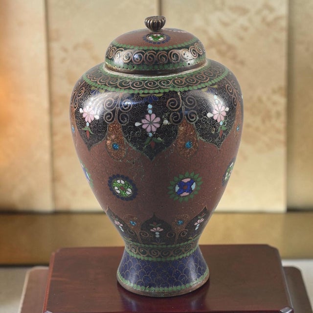 The Vintage Japanese Meiji Cloisonné Enamel Floral Covered Jar is a unique piece of Asian antique craftsmanship,...