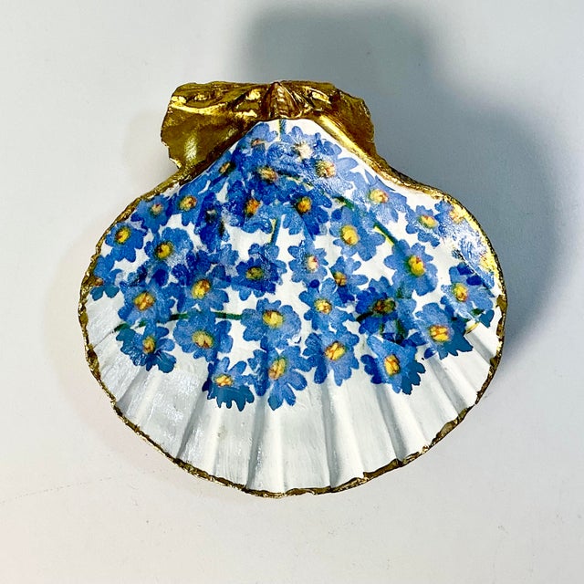 We love this pretty trinket catchall seashell dish. It’s a Folk Art craft piece. The artist has added a floral designed...