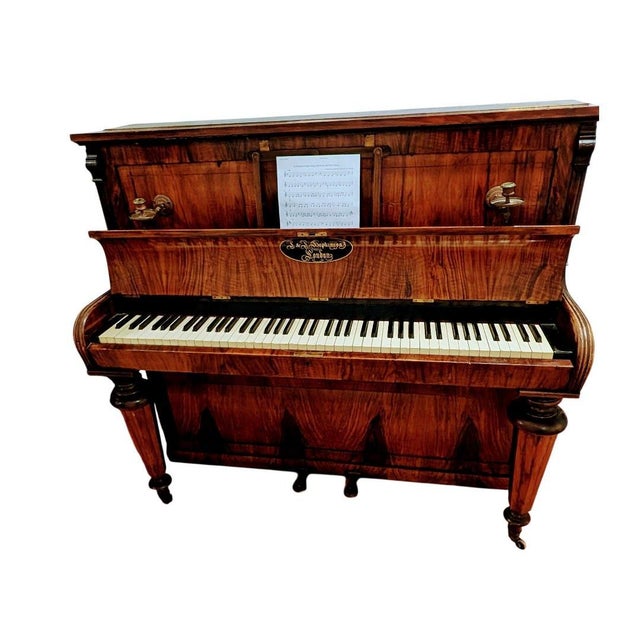 This is an oval-decal-style J. & J. Hopkinson piano, made in England between approximately 1865 and 1895. This antique...
