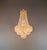 An elegant chandelier featuring a dense crystal structure and a distinctive shape. Its tapering form and decorative upper...