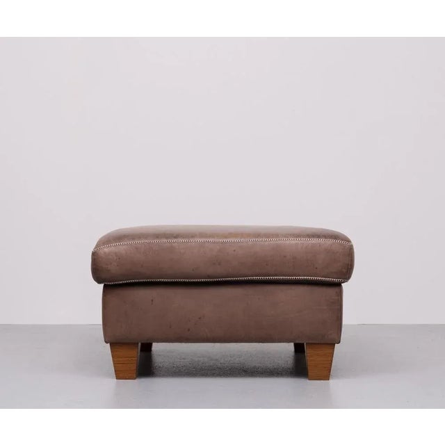 Very nice luxurious Pouf or Ottoman . Stich Leather . Beautiful Brown color .Comes with just the right amount of wear .