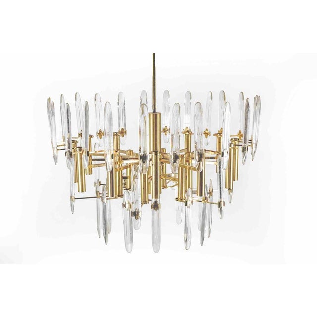 Vintage Metal, Brass and Crystal Chandelier realized by an italian production in 1970s. Very good condition. Up to 250V...