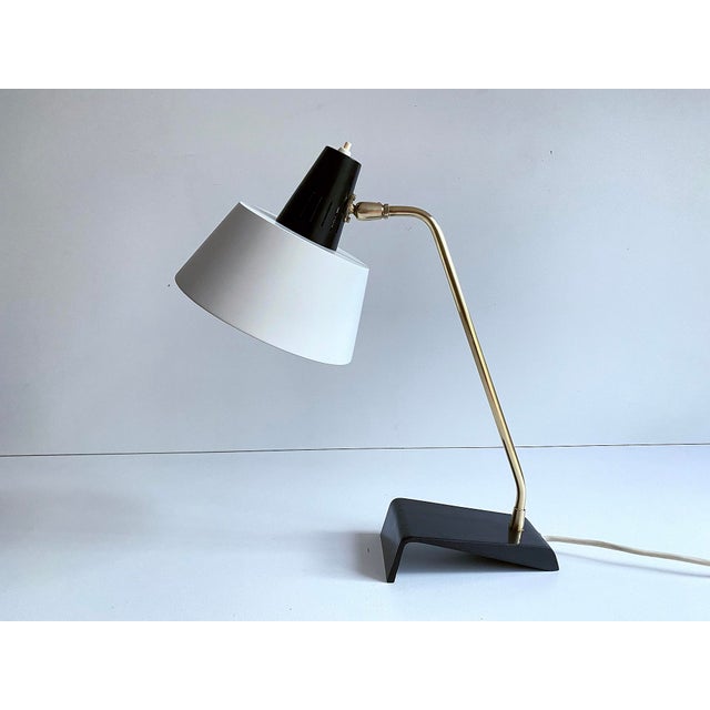 Kaiser Desk lamp, Modell 6813, 1960s, featuring a cantilivered black enameled cast iron base, brass stem and superimposed...
