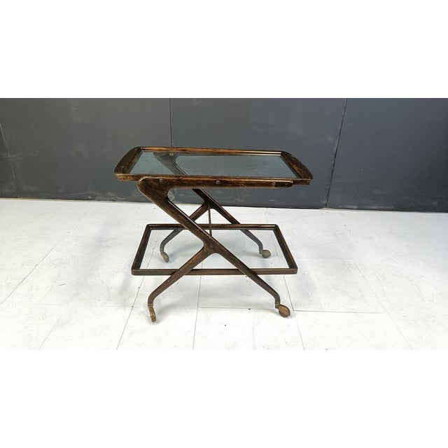 Fifties two tier serving trolley or bar cart in the style of Cesare Lacca. Fantastically crafted and elegant italian...