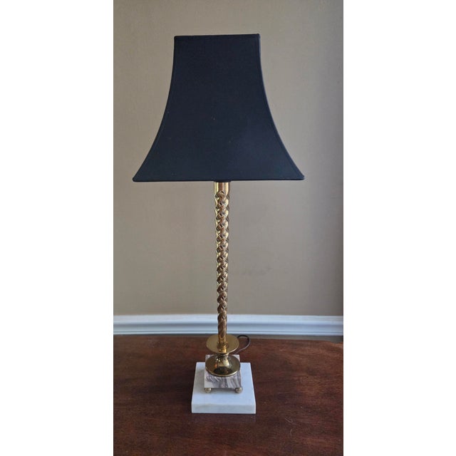 Simple classic design spiral brass on a 2 tier marble pedestal base. Matte black shade with gold foil lining include.