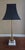 Simple classic design spiral brass on a 2 tier marble pedestal base. Matte black shade with gold foil lining include.