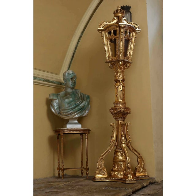 An exceptional pair of monumental floor lanterns with a richly carved and gilded structure, designed for representative...