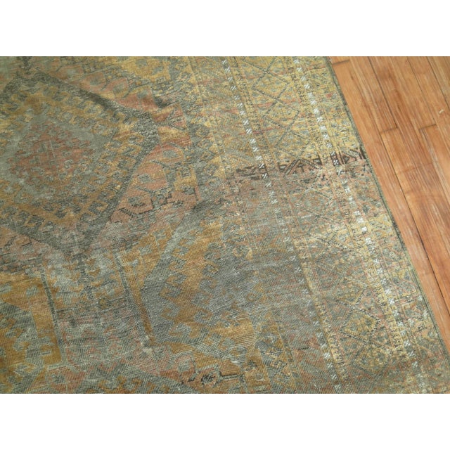 Pale brown, copper and caramel color Persian Balouch carpet from the early 20th century. Measures: 5'7" x 10'6".