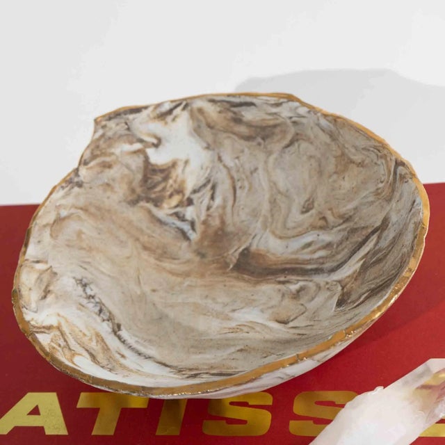 Unique handcrafted ceramic bowl with marbled tan/off-white glaze, gold metallic rimmed edge. Signed "B. Holzke". Organic...