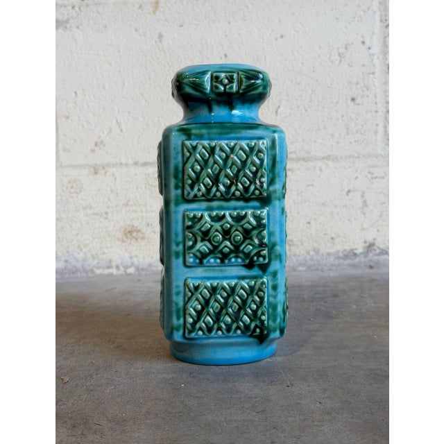 This vintage ceramic vase features an eye-catching rectangular form with a highly textured, relief geometric design across...