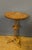 Louis Philippe tripod gueridon in cherry wood. It features an intermediate shelf, a turned stem and a turned round cup-...