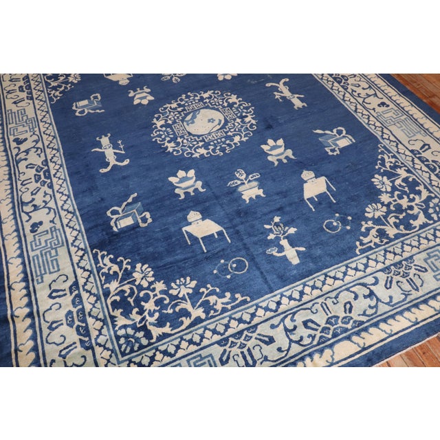 an early 20th century room size chinese rug in blues and creams Measures: 8' x 9'9''