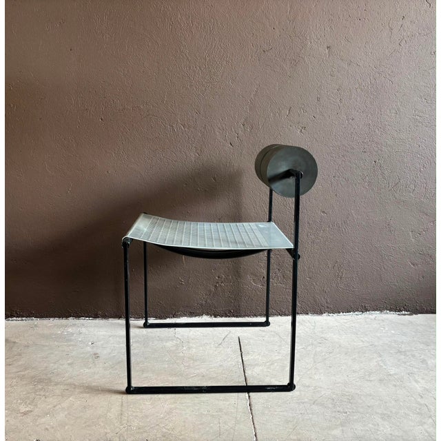 The iconic mario botta "prima" chair, manufactured by alias, 1982, italy. black enameled steel, polyurethane foam...