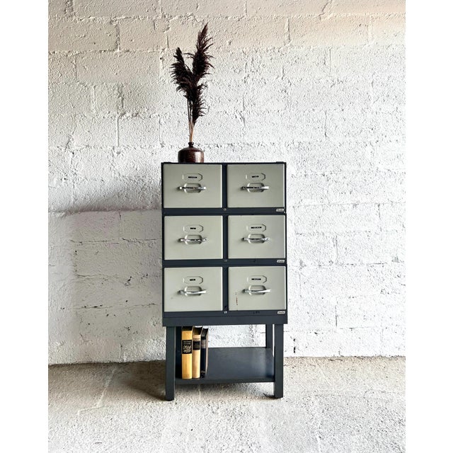 This Strafor filing cabinet is made of metal and has six drawers with chrome-plated metal handles and label holders. It...