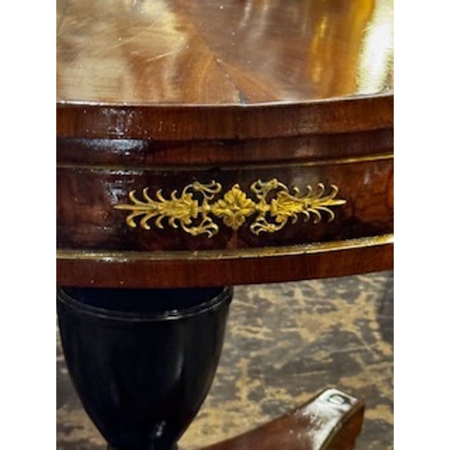 This product is a rare and elegant 19th century German walnut and ebony center table, featuring intricate craftsmanship...