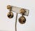 Early 1950s goldtone filigree and striated faux-tortoise resin beads drop clip back earrings. Marked crown "TRIFARI."...