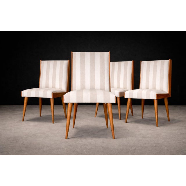 A sculptural and highly disciplined dining set by Giuseppe Scapinelli, this rare group of eight chairs embodies the...