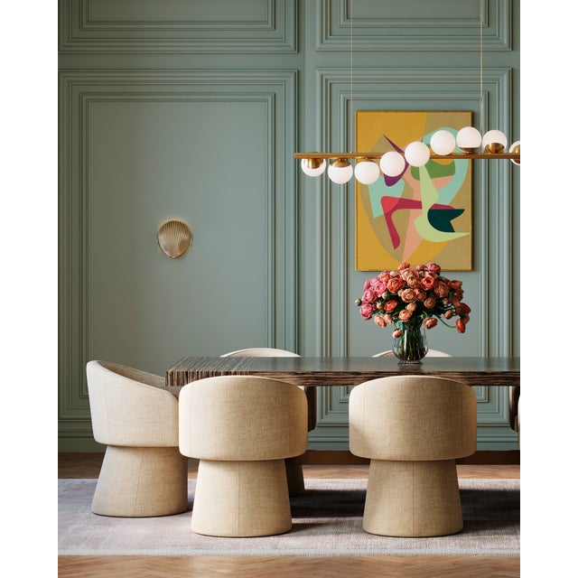 The Alexine Wall Sconce is a pretty shell-shaped gold sconce that washes a wall with splashes of light. Made of brass in...