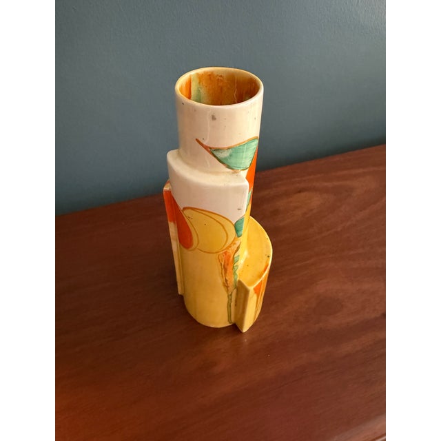 Hand-painted Clarice Cliff vase produced by Newport Pottery, England. A striking stepped geometric form decorated in the...