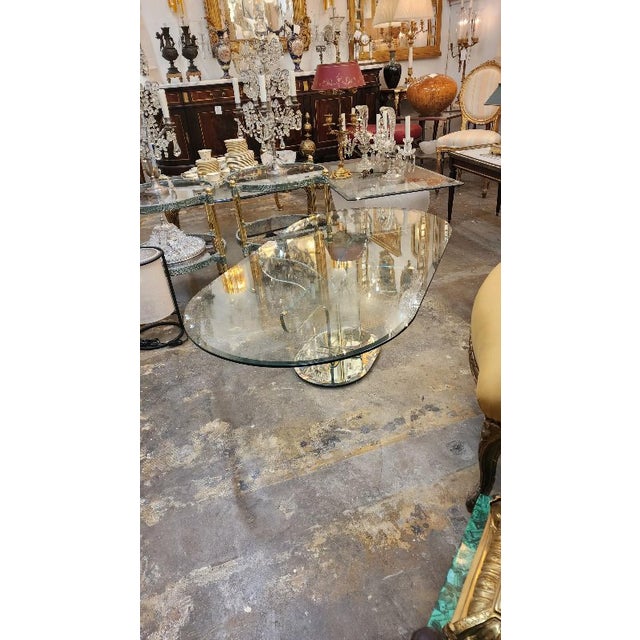 This listing features an Italian Art Deco coffee table with beveled edges, metal finishings, and a mirror base. Art Deco-...