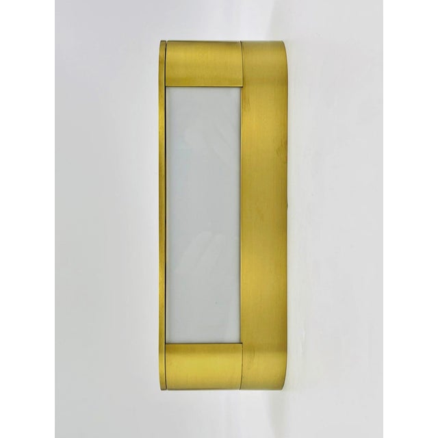 A refined example of Italian modern lighting design, this solid brass and Lucite wall sconce—model DC Mini Jolly by TCI...
