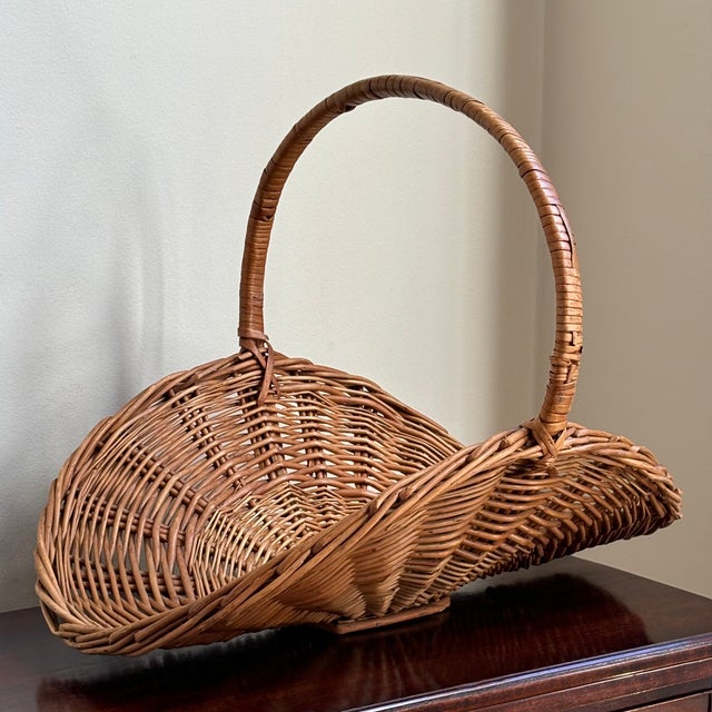 Offering a lovely mid-20th century rustic Eurpean style flower gathering basket featuring dramatic curves, pretty French...