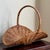Offering a lovely mid-20th century rustic Eurpean style flower gathering basket featuring dramatic curves, pretty French...