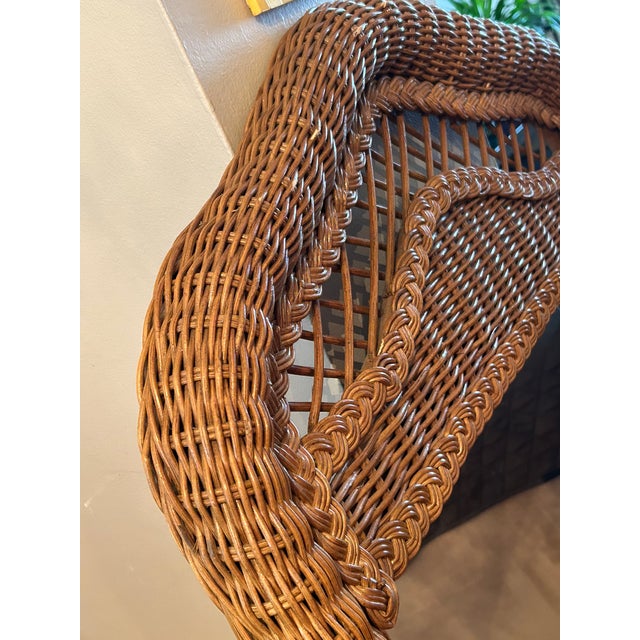 Vintage natural rattan and wicker arched wall or floor mirror showcases an intricate woven braid design with an open...