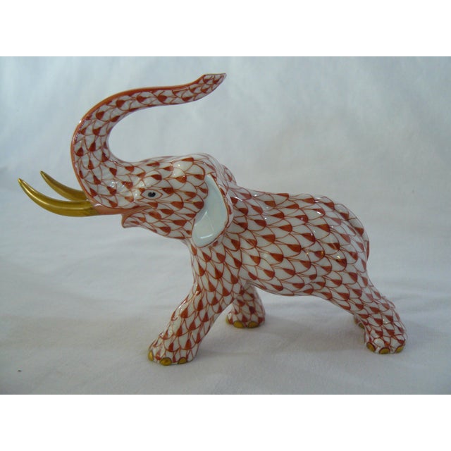 Herend rust fishnet elephant with 24K gold tusks. Excellent condition with no visible signs of wear. Height: 3.25" Width:...