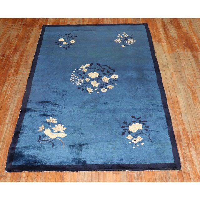 Mid 20th century Chinese Floral design rug in predominantly navy blue Measures: 4'10'' x 7'8''.