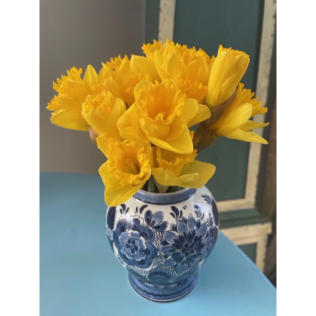 Delightful Delft blue porcelain vase decorated with blue flowers. It is dated at the early 20th century , 1912, as its...