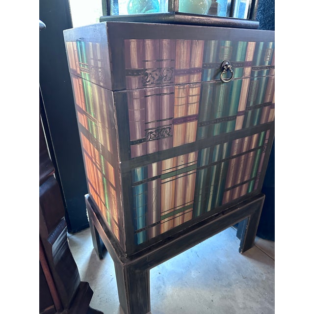 Unusual small trunk painted with Faux painted books all the way around it. Great storage for seasonal items. Papered...