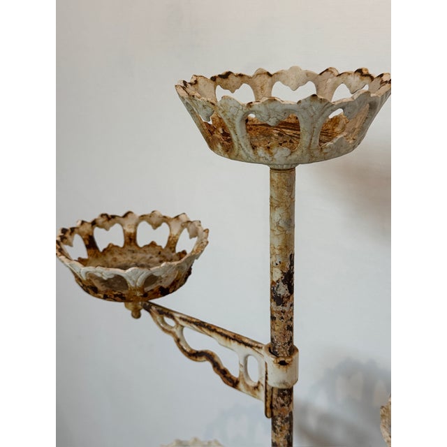 This Victorian cast iron revolving arm plant stand is a striking example of antique craftsmanship and enduring design,...