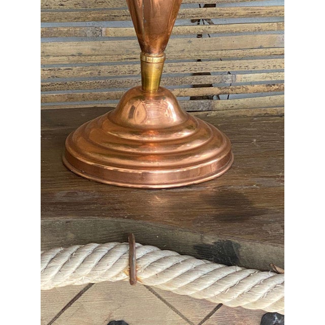 This umbrella stand is in brass and cooper. It has been made in Italy in the 1960s. The rod and the base are in brass, and...