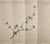 Artisan hand-painted minimalist chinoiserie mural featuring an elegant extending peach blossom branch with soft blush...