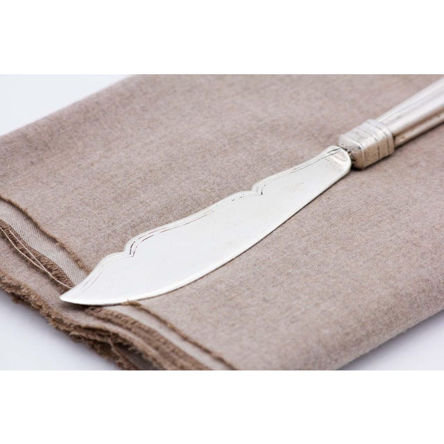 Silver Fish Knife with Grooves and Handle Reliefs, in Very Good conditions. Designed 1920 to 1949 This piece has an...