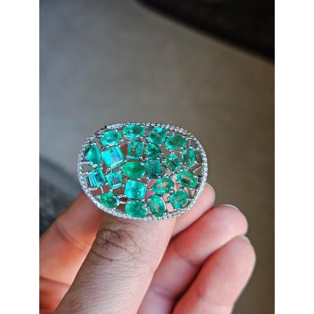 A very beautiful and modern, Emerald Cocktail Ring set in 18K White Gold & natural Diamonds. The weight of the Emeralds is...